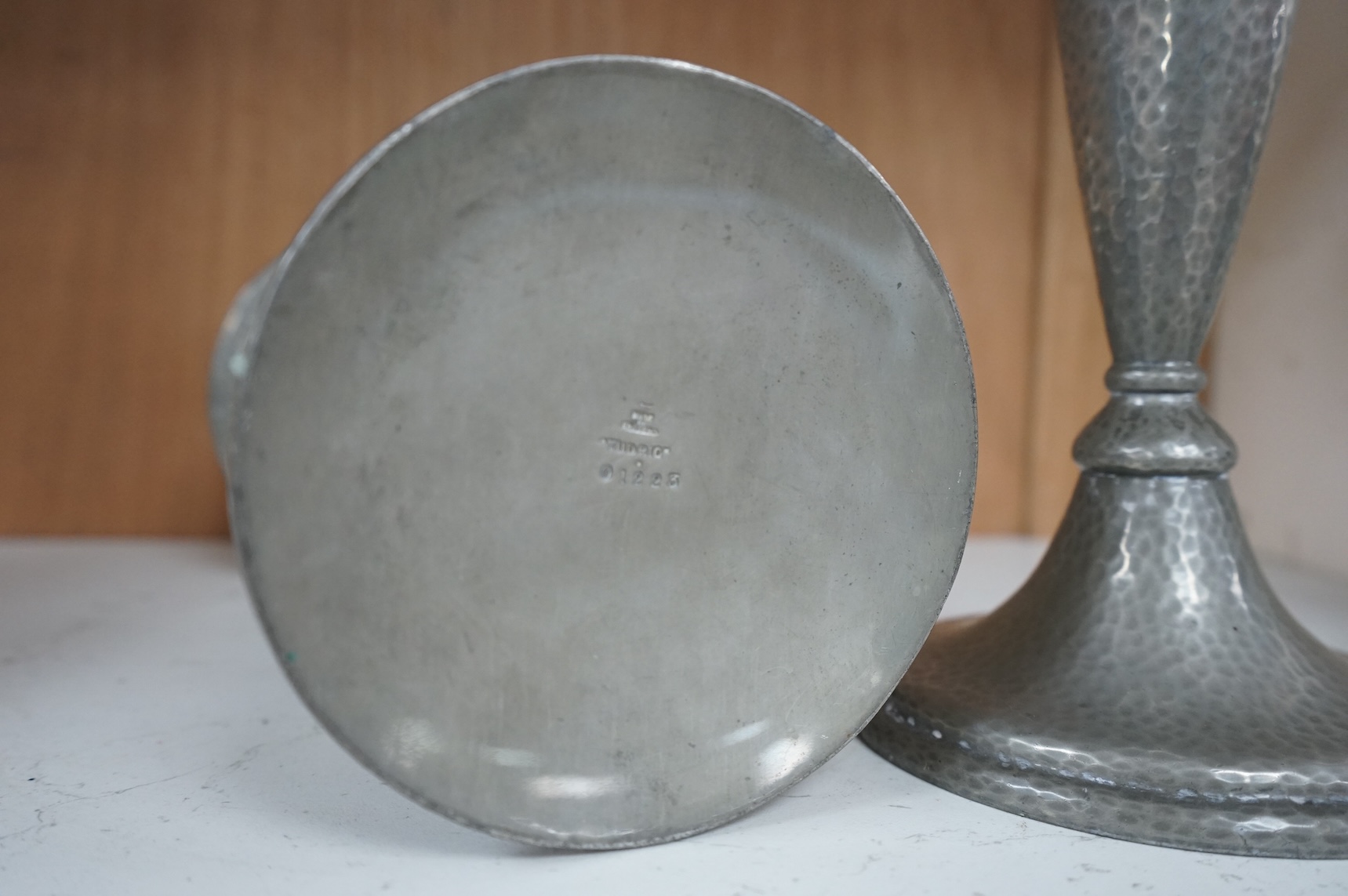 A pair of Liberty Tudric pewter candlesticks, numbered 01223 to the bases, 24cm high